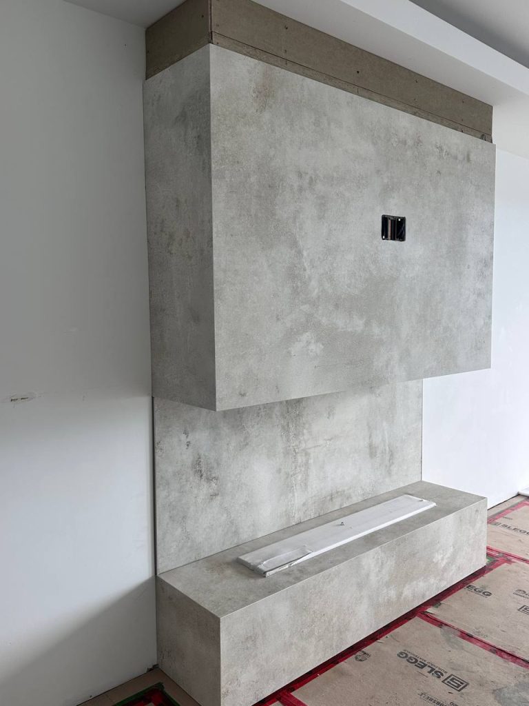 Modern large-format porcelain fireplace surround installation